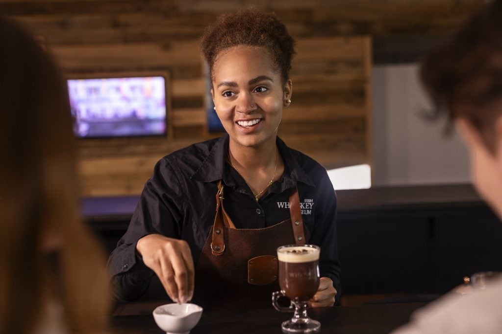 Woman serving drinks at the Irish Whiskey Museum in Dublin.